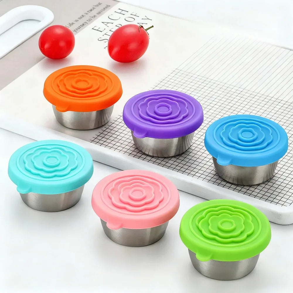 Six colorful PrepCups on a cutting board beside cherry tomatoes