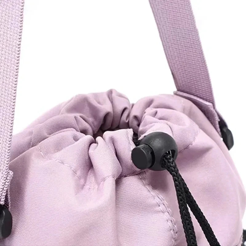 Close-up of CarrySling drawstring closure with cord lock toggle on light purple fabric
