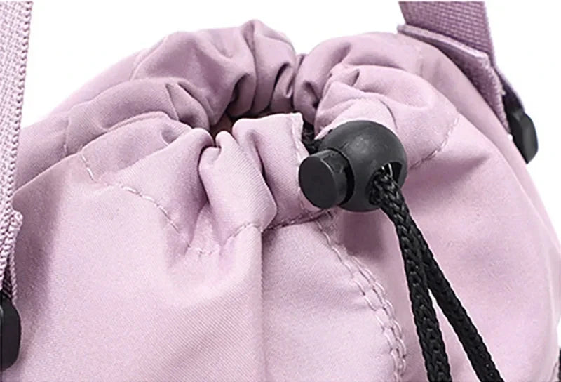 Wide close-up of light purple CarrySling top opening cinched shut with drawstring cord and toggle