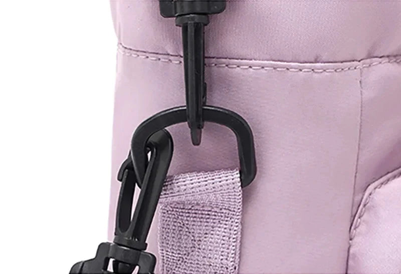 Close-up of detachable black clip connecting adjustable strap to light purple CarrySling bag