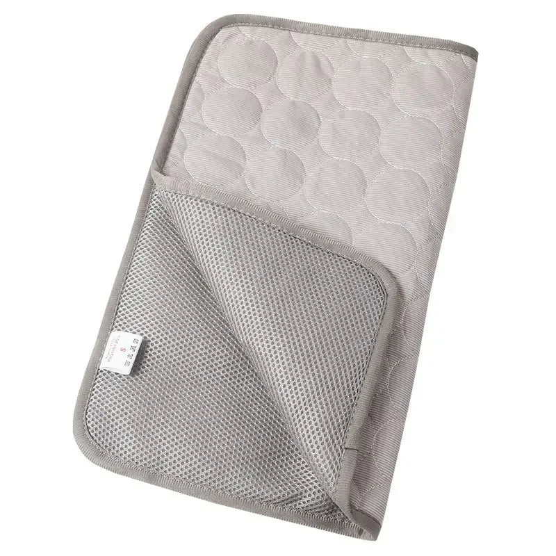 Gray CoolMat folded to show quilted top and mesh underside with care label
