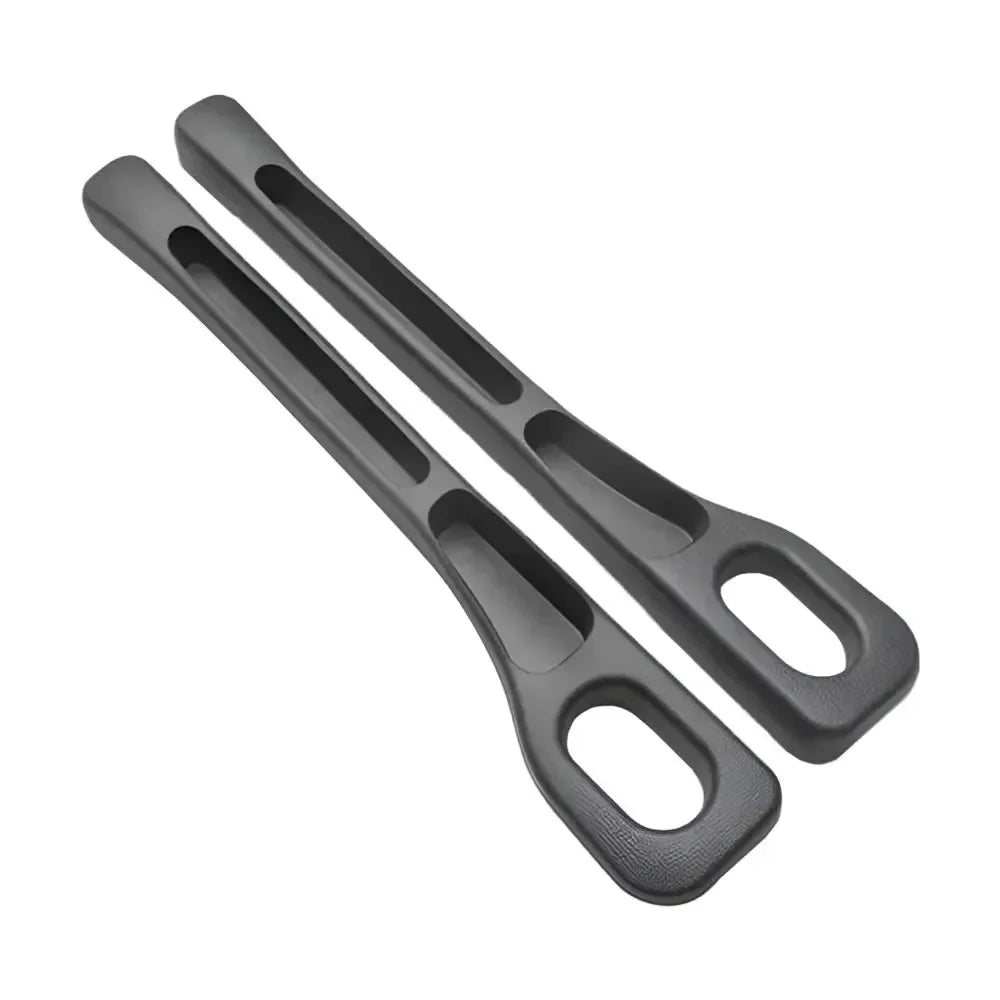 Pair of black GapGuard seat gap fillers on white background, showing curved shape and slotted design