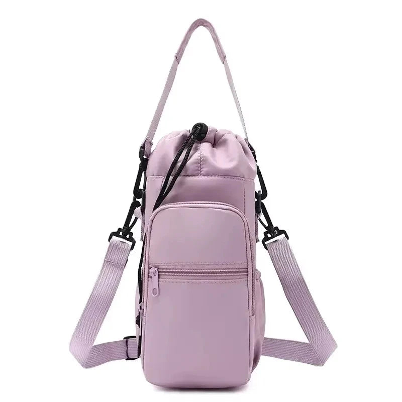 Light purple CarrySling bottle carrier bag with adjustable strap, front zipper pocket, and drawstring top