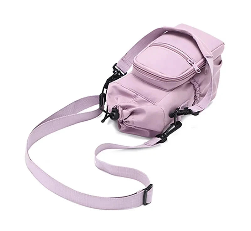 Overhead angled view of light purple CarrySling bag with front zip pocket and looped straps