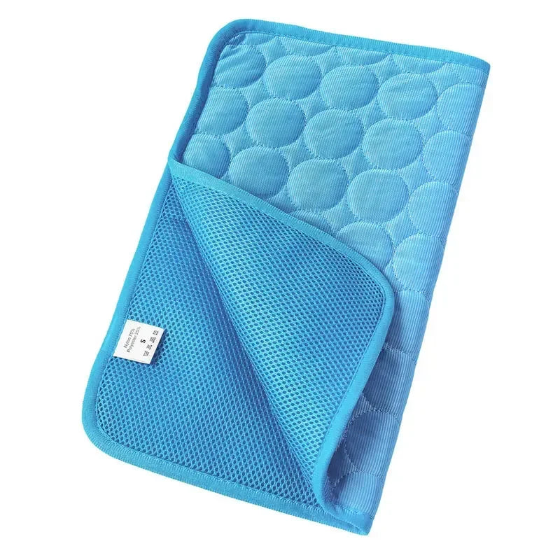 CoolMat pet cooling mat in blue, folded to show quilted top and mesh underside
